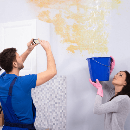 women holding a bucket to catch water